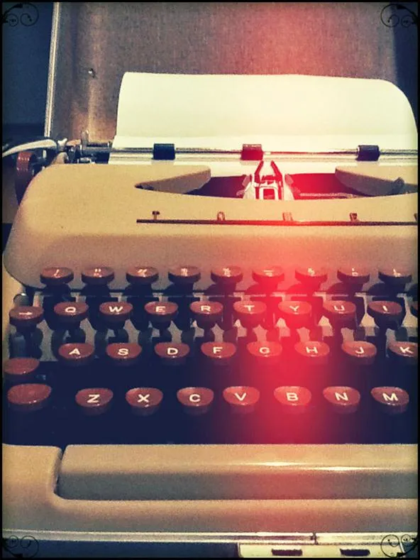 Vintage typewriter with a sheet of paper inserted.