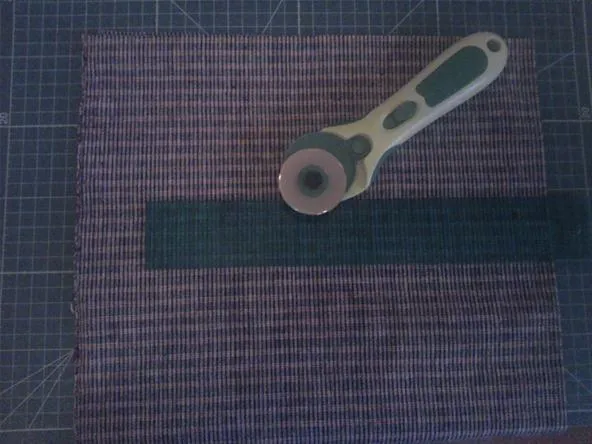 Cutting mat with a rotary cutter and ruler.