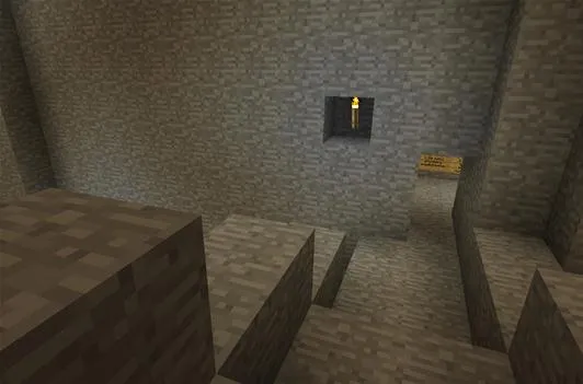 A stone staircase leading into a cave with a small window and distant lighting.