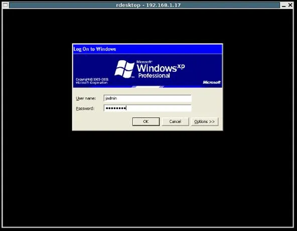Windows XP login screen with username and password fields.
