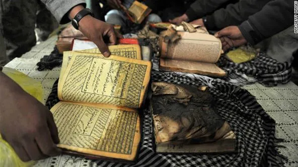 Damaged books being examined on a cloth surface.
