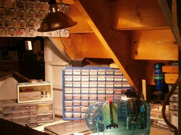 A well-organized workspace featuring storage boxes and a unique decorative lamp.