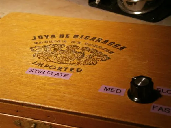Vintage wooden stir plate labeled "Joya de Nicaragua Imported" with adjustable settings.