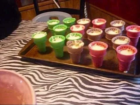 Colorful dessert cups arranged on a tray with a zebra-print tablecloth.