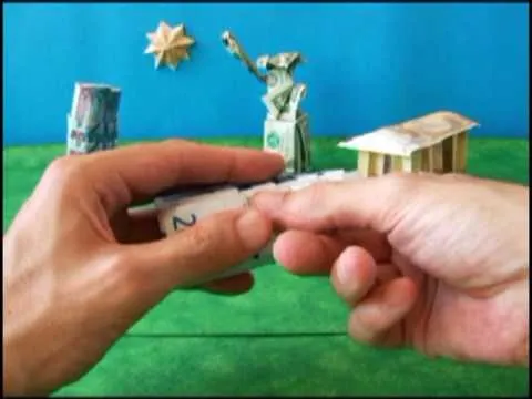 Origami figures and a paper representation of money on a colorful background.