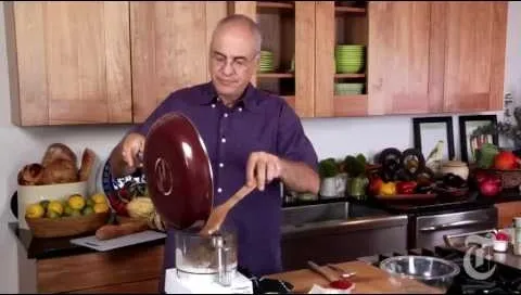Chef using a food processor in a modern kitchen.