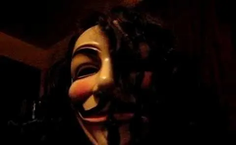 Guy Fawkes mask in dim lighting.