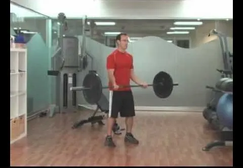Man lifting weights in a gym setting.