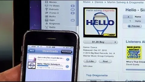 Mobile device displaying a music downloading interface alongside a desktop view of a music store.