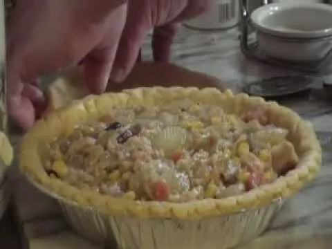 Homemade savory pie being prepared on a kitchen counter.