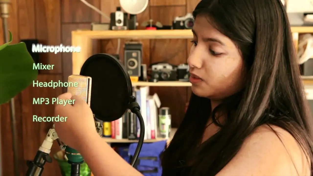 Young woman adjusting equipment in a home recording studio.