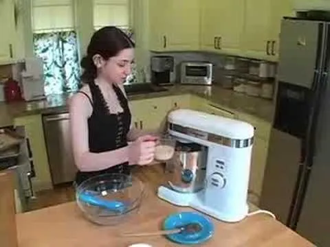 Girl baking in a kitchen with a stand mixer.