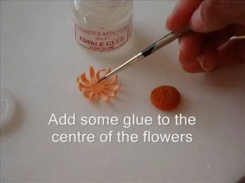 Applying glue to the center of decorative flowers.