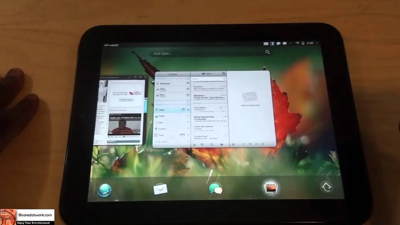 Tablet displaying multiple applications and a colorful background.