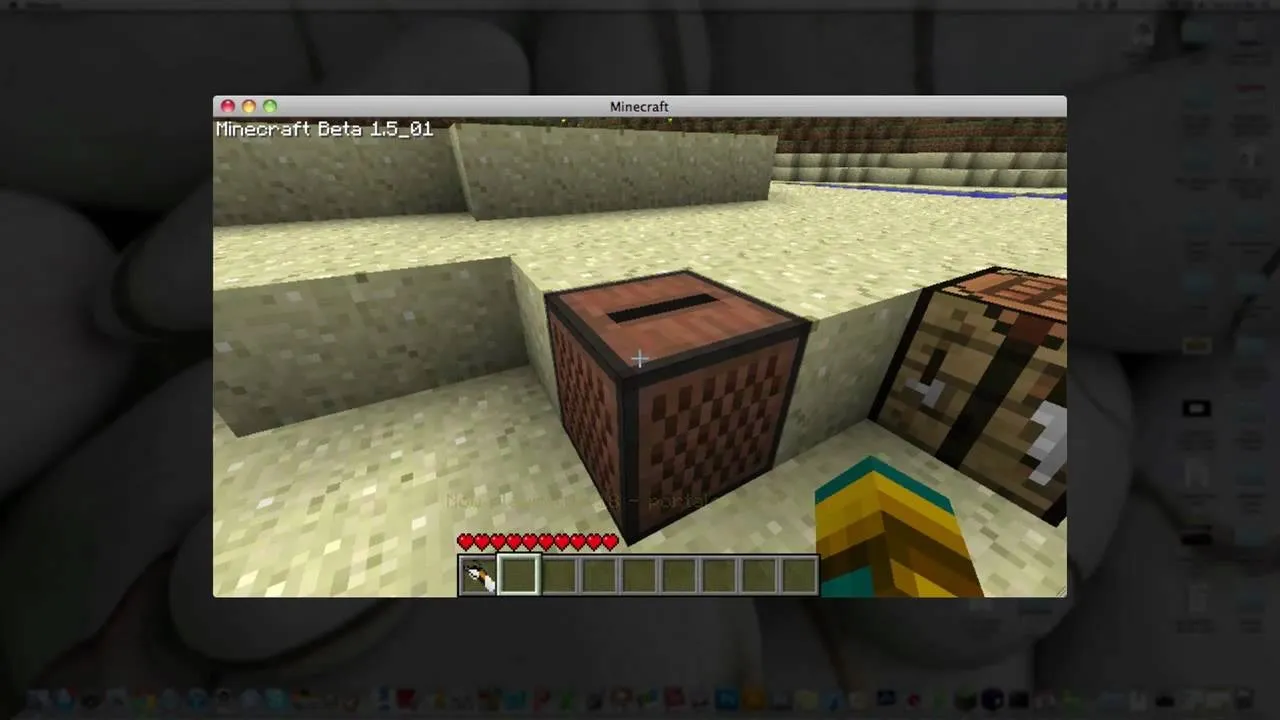 A Minecraft interface showing a note block next to a crafting table on sandy terrain.