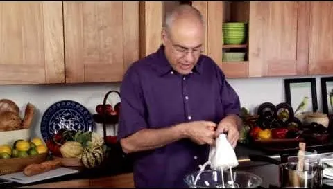 A chef preparing a dish in a kitchen.