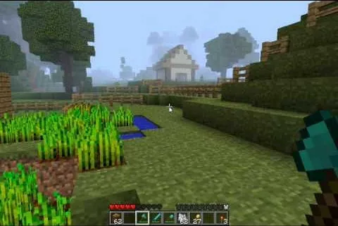Minecraft landscape with a farmhouse, fields, and trees.