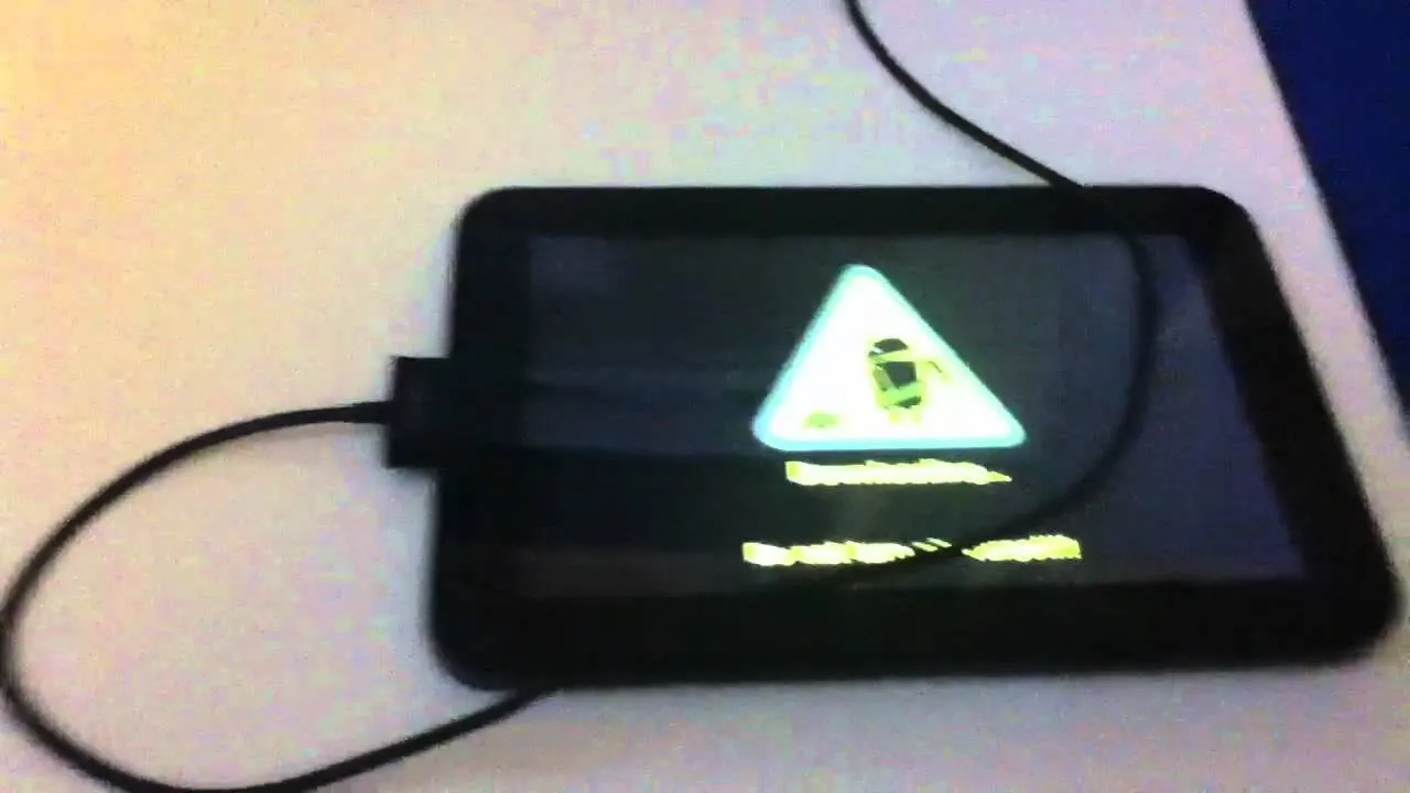 Tablet displaying a warning message with a battery symbol.