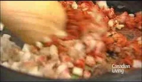 Cooking ingredients being stirred in a pan.