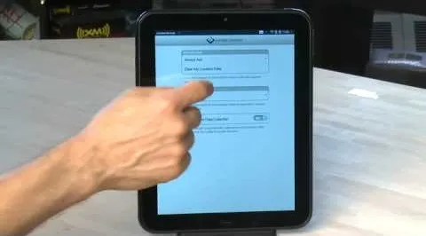 Person interacting with a tablet displaying a web form.