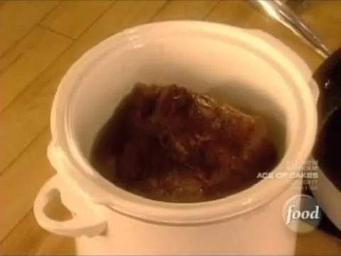 Slow-cooked beef stew in a white crockpot.