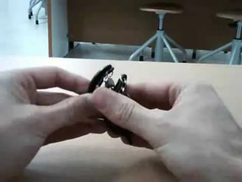 Close-up of hands assembling or disassembling a wristwatch.