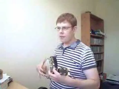 Person playing a musical instrument in an indoor setting.