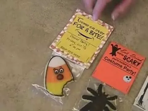 Halloween-themed party invitations and decorations, including candy corn and a spider motif.