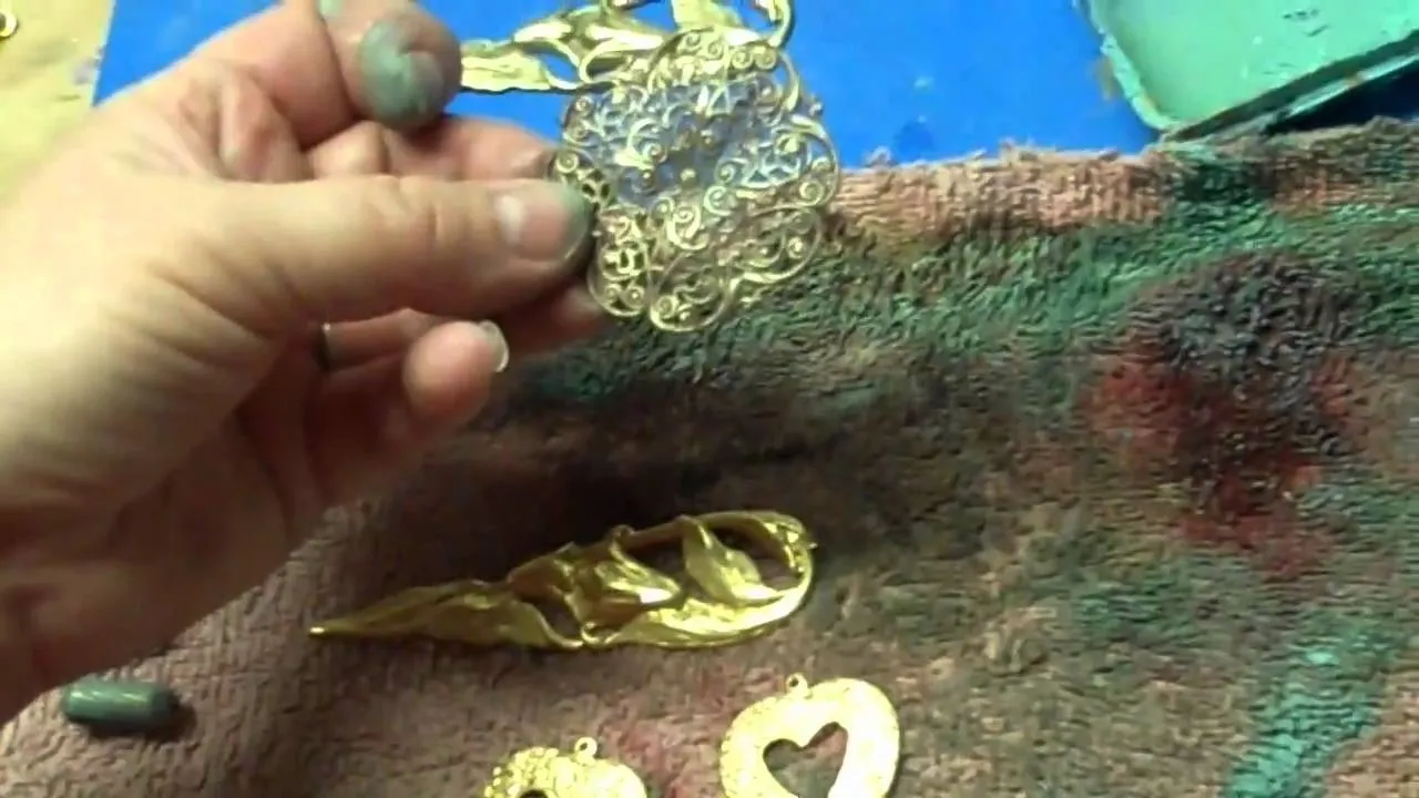 Handcrafted metal jewelry pieces displayed on a work surface.