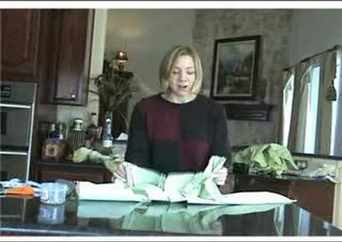 A woman preparing food in a kitchen.