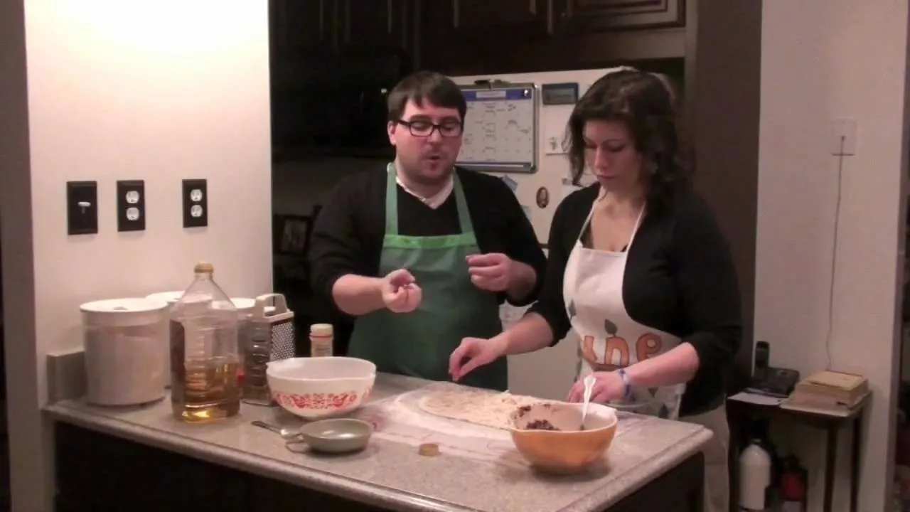 Hands preparing a meal, adding ingredients to a dish.