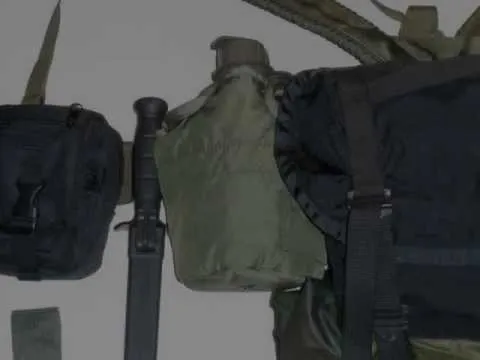 Tactical gear layout with a backpack, canteen, and knife.