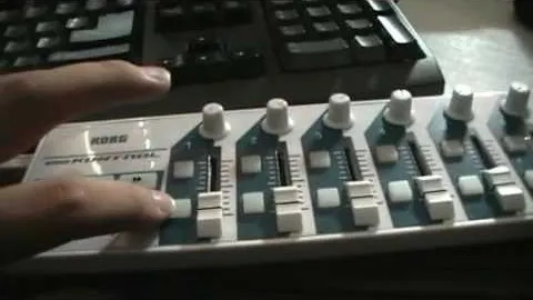 Control surface with sliders and knobs for audio mixing.