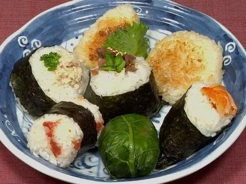 Sushi assortment on a blue plate.