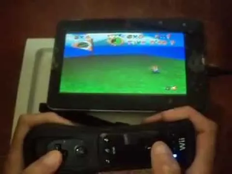 Person playing a video game on a tablet using a game controller.