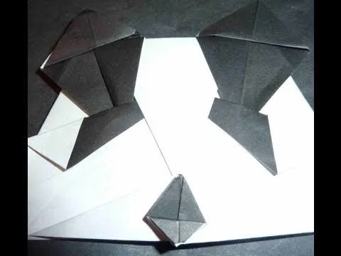 Origami figures arranged on a black background.