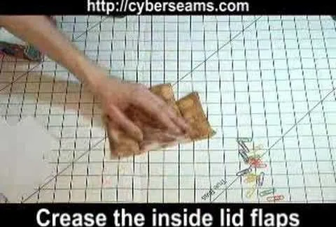 Creasing the inside lid flap on a sewing project.