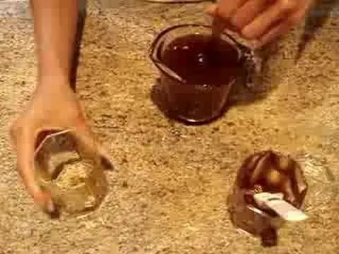 Dessert preparation with chocolate sauce and ingredients on a countertop.