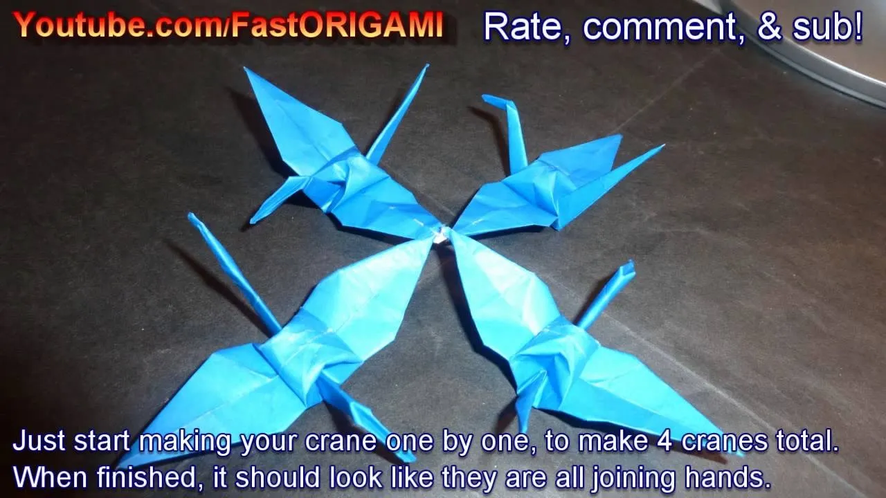 Four blue origami cranes arranged to appear as if they are turning towards each other.