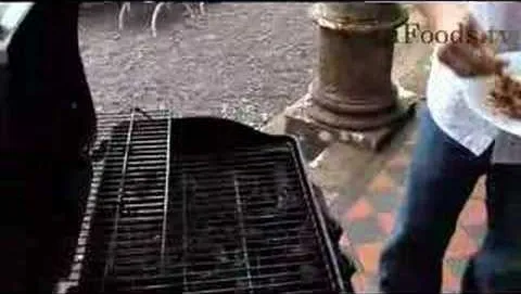 Grill with food being prepared outdoors.
