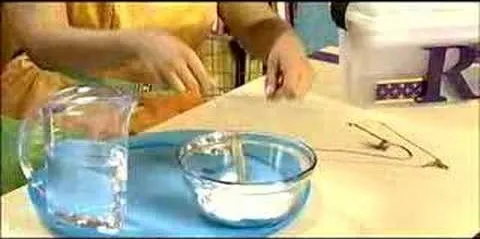 Experiment demonstrating liquid measurements with water and a measuring cup.