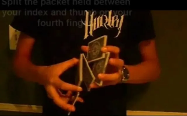 Person demonstrating a card trick with playing cards.