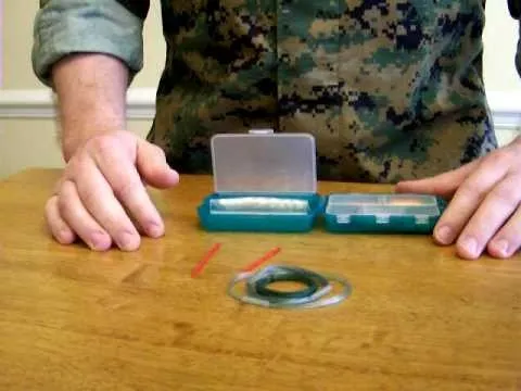 First aid kit and supplies on a wooden table.