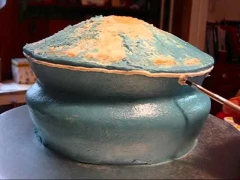 Blue and tan cake designed to resemble a mountain.