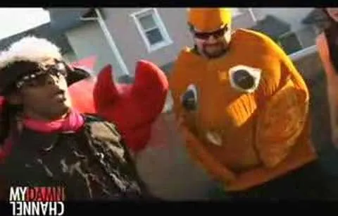 Two individuals dressed in quirky costumes, one resembling a lobster and the other a fish.