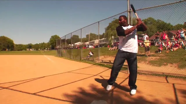 Man preparing to bat on a baseball field.