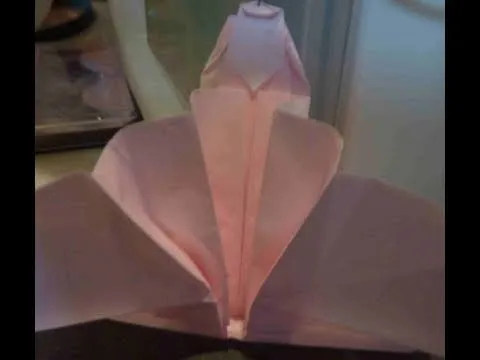 Pink origami flower with detailed petal folds.