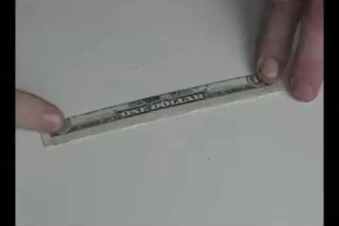 A person holding a ruler on a flat surface.