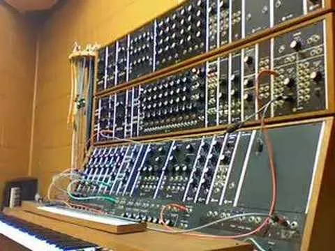 Synthesizer setup with multiple sound modules and a keyboard.