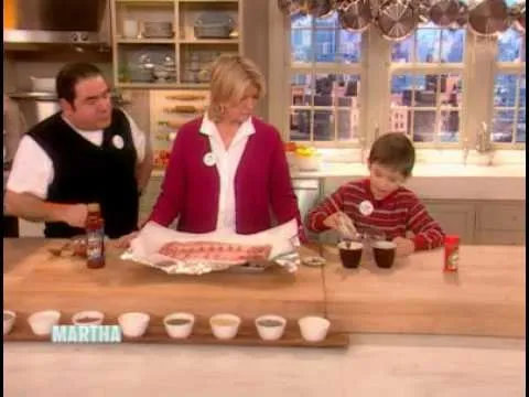 Cooking demonstration with a woman and two boys preparing dishes in a kitchen.
